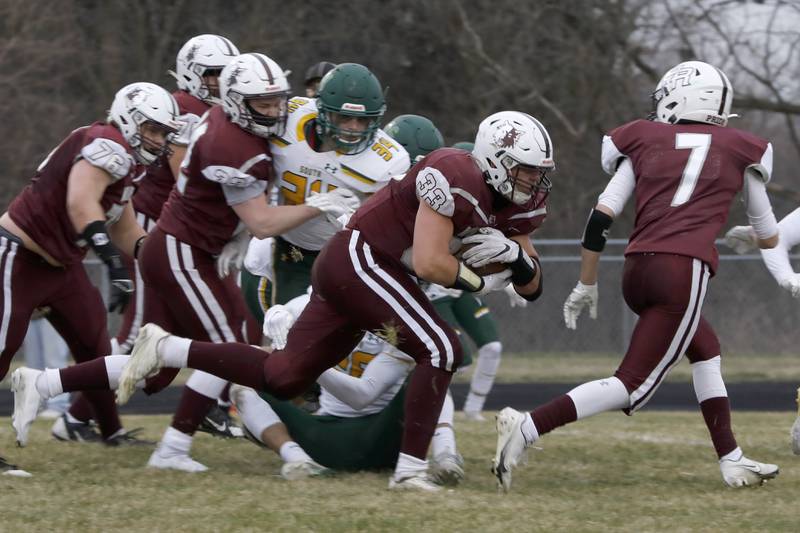 Prairie Ridge’s Carter Evans protects the ball as he runs it in for a touchdown Friday, March 26 during their game against Crystal Lake South.