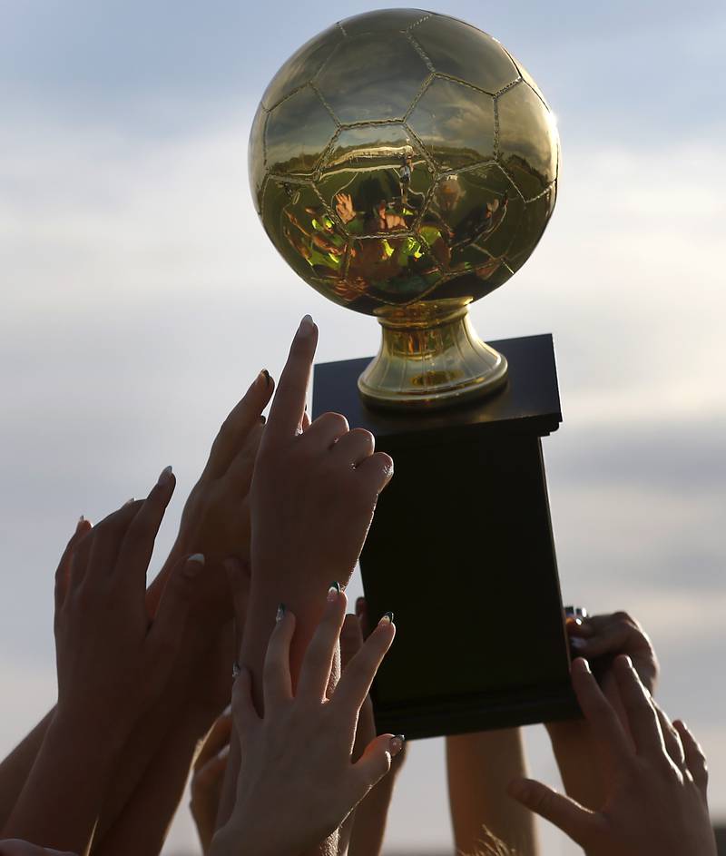 Richmond-Burton players raise the trophy after they defeated Johnsburg 4-0 in the Kishwaukee River Conference Girls Soccer Tournament Championship Match on Wednesday, May 1, 2024, at Richmond-Burton High School.