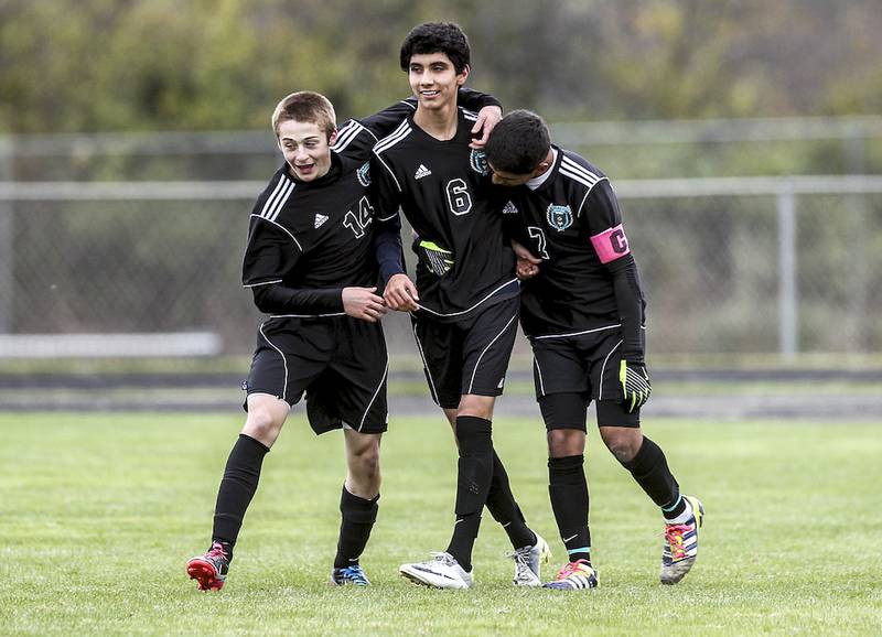 Woodstock North's Josh Jandron (left), Victor Ortiz and Julio Campos celebrate a goal by Ortiz during a Class 2A Marian Central Regional semifinal against Woodstock on Oct. 23. Woodstock North and Woodstock are looking into the possibility of leaving the Fox Valley Conference.