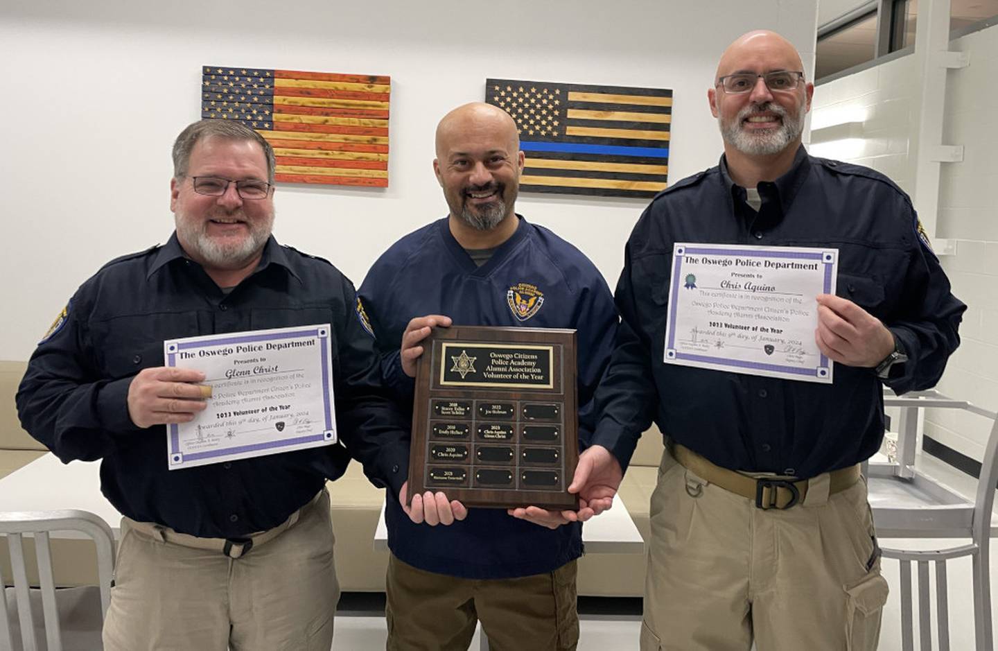 Volunteer of the Year awards were presented to Oswego Police Citizen’s Police Academy Alumni Association members Glenn Christ, left, and Chris Aquino, right, by coordinator Officer Steve Bailey.