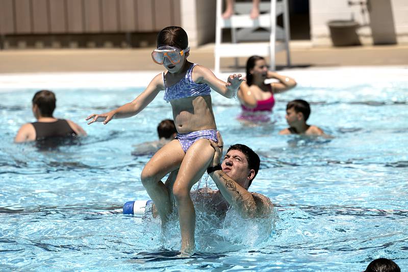 Adam Becker of Polo launches daughter Lennox, 7, at the Polo pool Wednesday, June 5, 2024. The Becker family is looking forward to lots of time spent in the waters of the swimming hole.