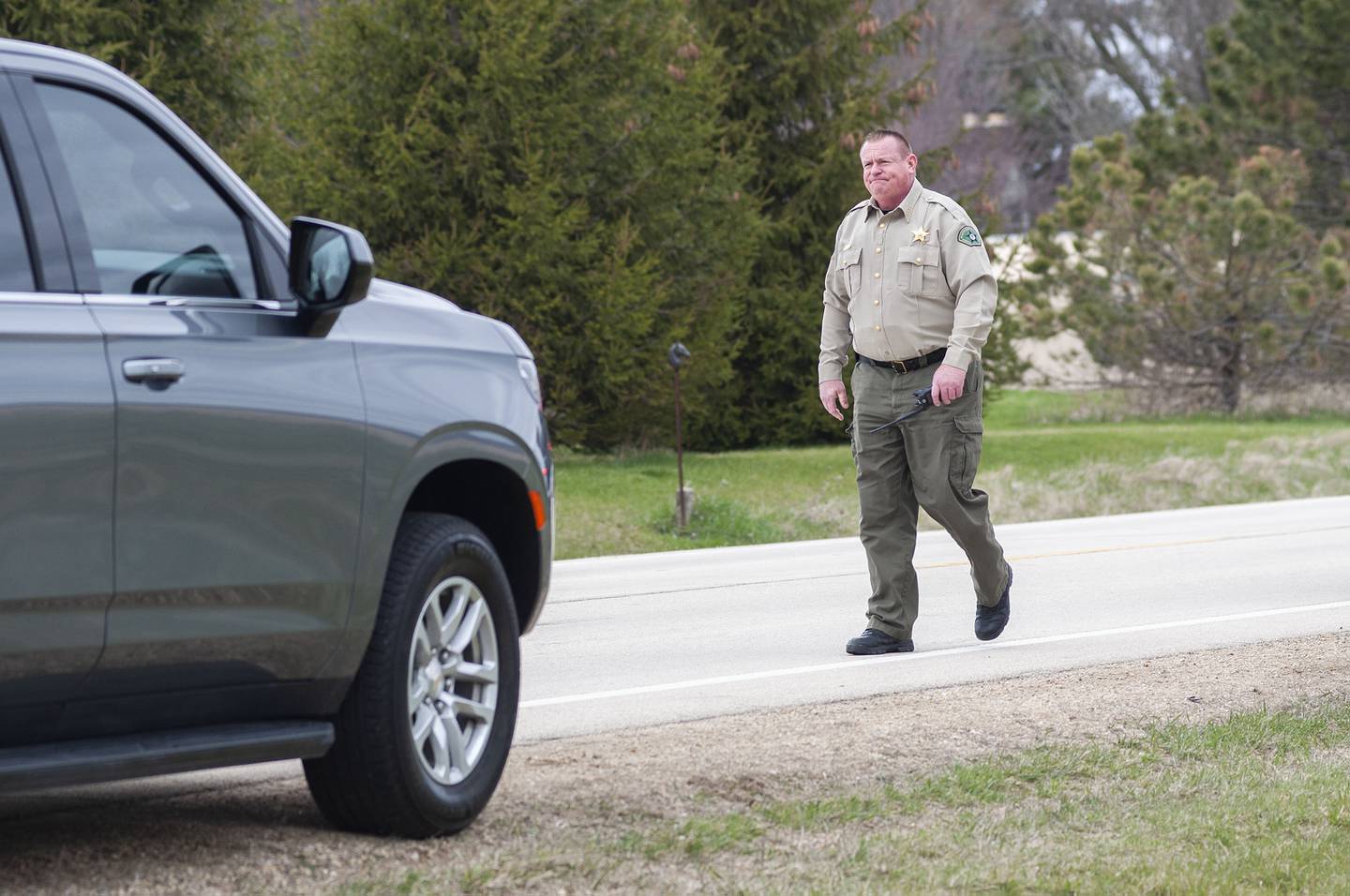 Whiteside County sheriff John Booker works at the scene of a fatal shooting that took place at 9:30 a.m. north of Sterling Monday, April 18, 2022.