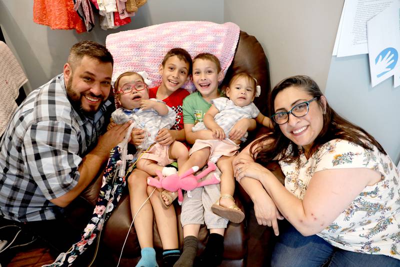 Scott Algrim and Jaclyn Vasquez-Algrim, with their children (from left, Ava, 1, Jackson, 7, Easton, 6, and Olivia, 1, in their Elburn home. The family welcomed twin girls Ava and Olivia prematurely in October 2020. Ava was finally able to come home on Thursday, June 2, 2022.