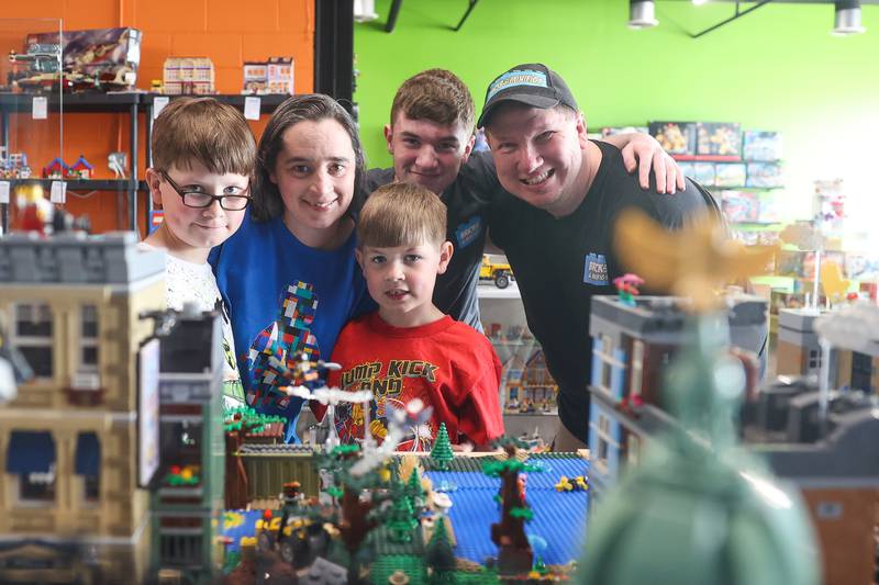 Ryan Linsner along with his wife, Sarah Linsner, and three kids, Chris, clockwise, Michael and Nicholas pose at the couple's LEGO-focused Bricks & Minifigs of Crest Hill store on Thursday, June 8, 2023.