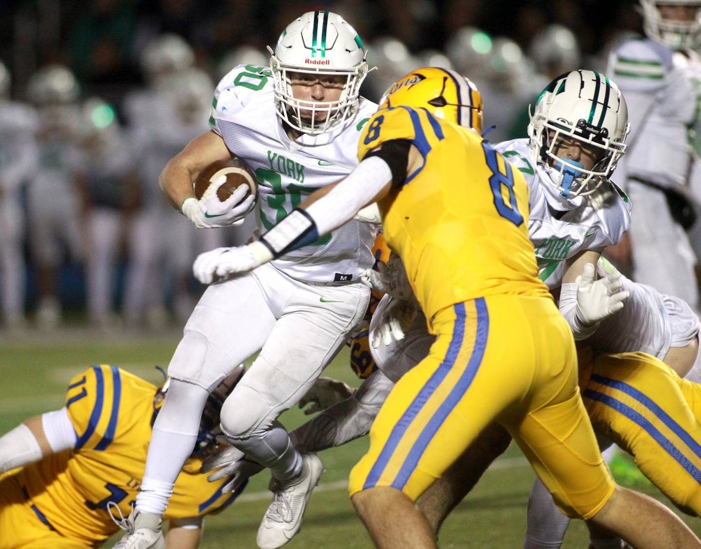 York’s Jake Melion carries the ball as he’s tackled by Lyons Township’s Luke Wehling during the Class 8A second round football playoff game in Western Springs on Saturday, Nov. 4, 2023.