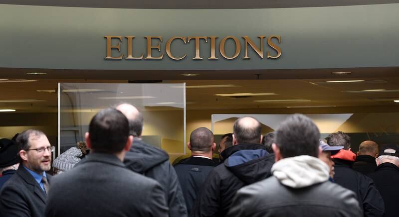 Candidates wait to turn in their paper on the first day of filing at the Kane County Clerk’s office Monday, March 7, 2022 in Geneva.