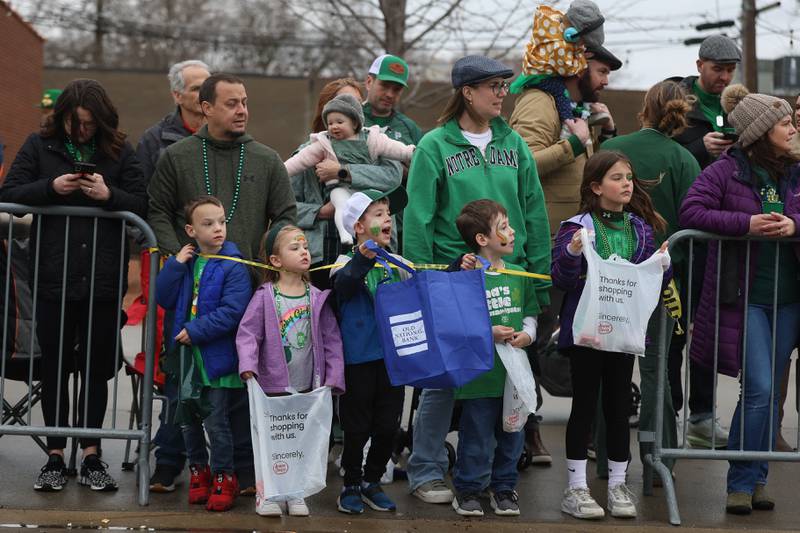 Kids line up along the street waiting to collect candy at the annual Plainfield Hometown Irish Parade on Sunday, March 15, 2026 in Plainfield.