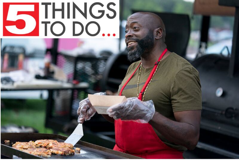 George Lucas with Rolling Smoke BBQ serves up an order of pork belly cakes during the first night of the 10th annual Blues, Brews & BBQ on Friday, August 20 at Petersen Park in McHenry. The event, which runs through Sunday, featured live music, barbecue and drinks. Ryan Rayburn for Shaw Local