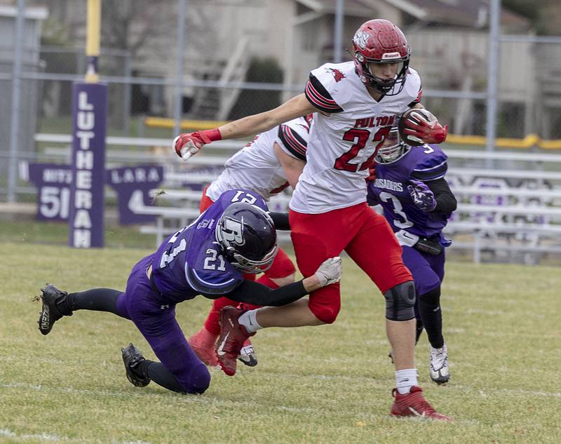 Fulton’s Baylen Damhoff is pulled down by Rockford Lutheran’s Johah Miller Saturday, Nov. 5, 2022 during a round two football playoff game against Rockford Lutheran.