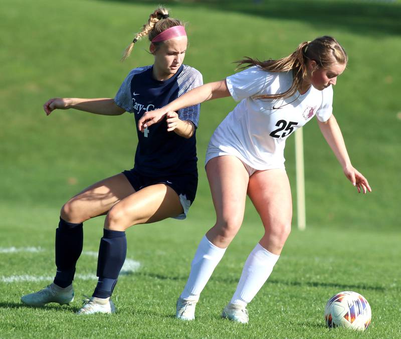 Prairie Ridge’s Anna Mertel, right, gets past Cary-Grove’s Ava Santucci in varsity girls soccer at Cary-Grove High School in Cary on Tuesday, April 29, 2025.