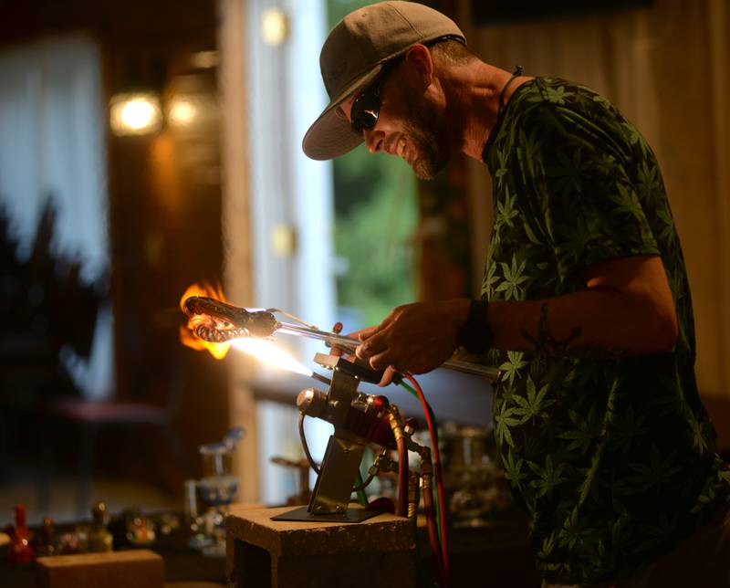 Gemini Kyle, from the state of Oregon, blows glass during "Cannafest" at Elks Page Park, north of Dixon, on Saturday, July 8. The event was hosted by Herbal Essentials, a downtown Dixon business with some proceeds benefiting Rosbrook Studios.