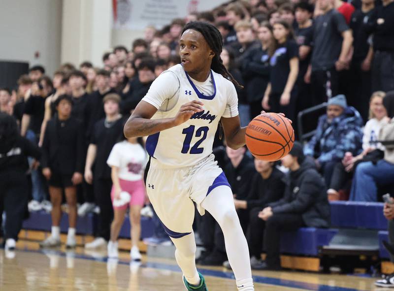 Riverside Brookfield’s Mehki Austin (12) brings the ball up court against Lyons during a boys varsity basketball game on Friday, Jan. 26, 2024 in Riverside, IL.