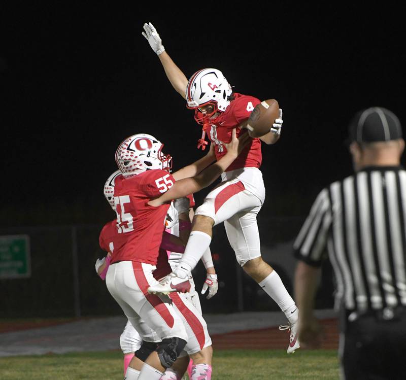 Oregon's Jakobi Donagen(4) celebrates with Zayden Vandesand (55) after scoring a touchdown in. the opening minutes against Winnebago on Friday, Oct. 17, 2025 at Landers-Loomis Field in Oregon. The Hawks edged the Indians 20-18.