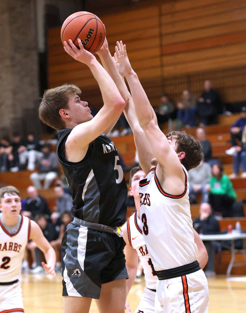 Kaneland's Bradley Franck shoots over DeKalb’s Brayson Barnhardt during their game Monday, Feb. 12, 2024, at Huntley Middle School in DeKalb.