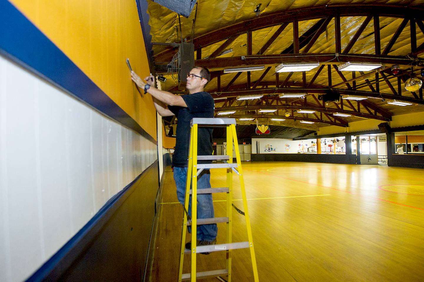 Rodolfo Cordova with Black Diamond works on installing a HVAC system at the Just For Fun Roller Rink in McHenry in this 2015 file photo. The roller rink closed its doors in the fall of 2020 and then burned down in what police say was an arson fire they allege was ignited by two teens in May. A Wisconsin-based company is considering pursuing redevelopment of the site and building affordable housing.