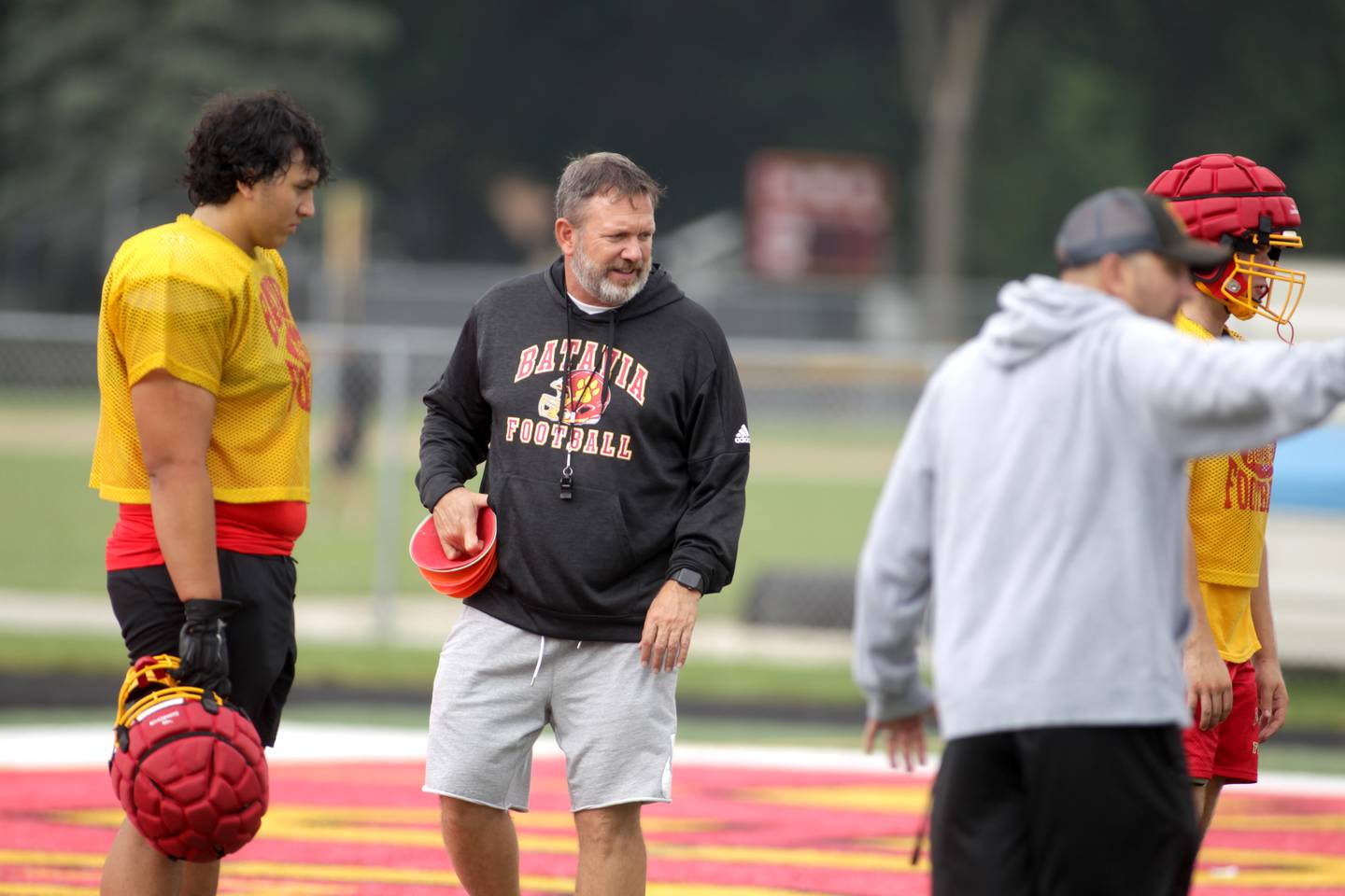 Batavia Head Coach Dennis Piron (center) works with his team during practice at the school on Thursday, Aug. 10, 2023.