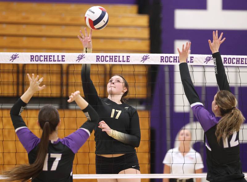 Sycamore's Laney Block tips the ball between Dixon’s Lucy Feick (left) and Izzy Queckboerner Thursday, Oct. 30, 2025, during their Class 3A regional championship match in Rochelle.