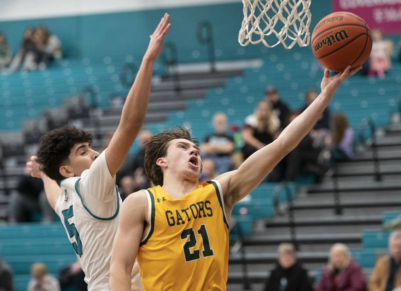 Crystal Lake South's Cooper LePage shoots past Woodstock North's Cesar Ortiz during their game on Saturday, January 7, 2023 at Woodstock North High School. Crystal Lake South won 65-42.  Ryan Rayburn for Shaw Local