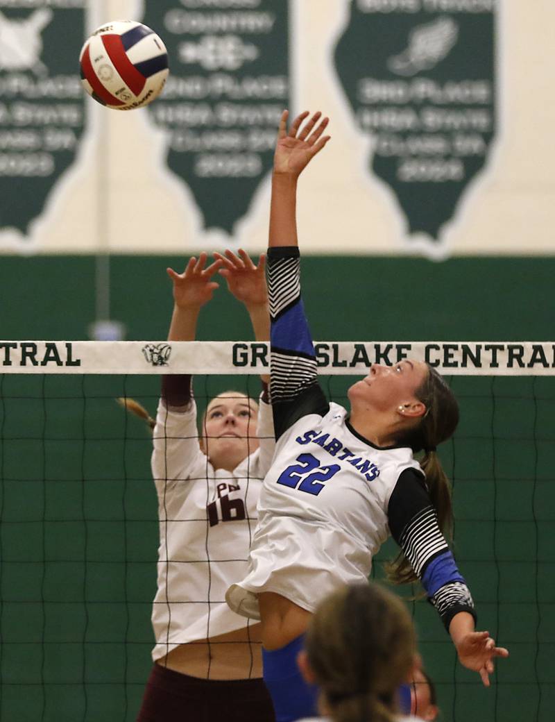 St. Francis' Addy Horner tries to tip the ball over Prairie Ridge's Adeline Grider during the IHSA Class 3A Grayslake Central Supersectional volleyball match on Monday, Nov. 11, 2024, at Grayslake Central High School.