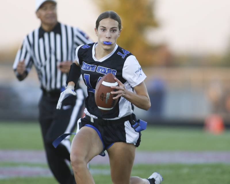 St. Charles North's Kaelie Tomalak (14) runs with the ball during Oswego East Regional Final flag football game between St. Charles North at Oswego East Thursday, Oct 9, 2025 in Oswego.