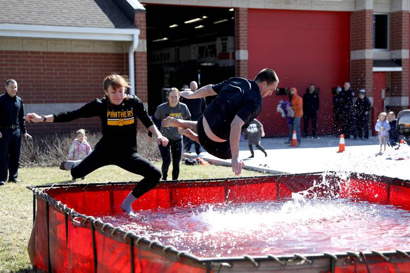 Edison Middle School teacher Savanna Dempsey and Assistant Principal Jim Zimmerman take the plunge ahead of Principal Rachel Bednar during the Wheaton Police Department’s annual polar plunge to benefit Illinois Special Olympics on Saturday, March 22, 2025 at the Wheaton Fire Department.