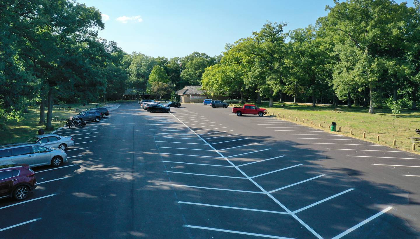 Vehicles park in a newly paved parking lot at Matthiessen State Park on Tuesday, Aug. 16, 2022 in Oglesby. Crews paved the parking lot and entrance road to Illinois Route 178. A sidewalk was also added along the entrance road.