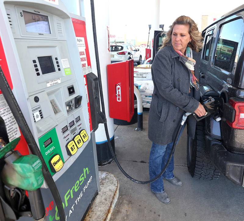 Paula Pinne, from Sycamore, fills up her vehicle Tuesday, March 8, 2022, at the Hy-Vee in Sycamore. US gas prices hit an all time high this week with local stations charging between $4.50 and $5.00 for a gallon of regular unleaded gasoline.