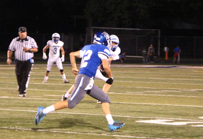 Newman’s Evan Bushman keeps and runs with the ball during a home game against Princeton on Friday, Sept. 8, 2023.