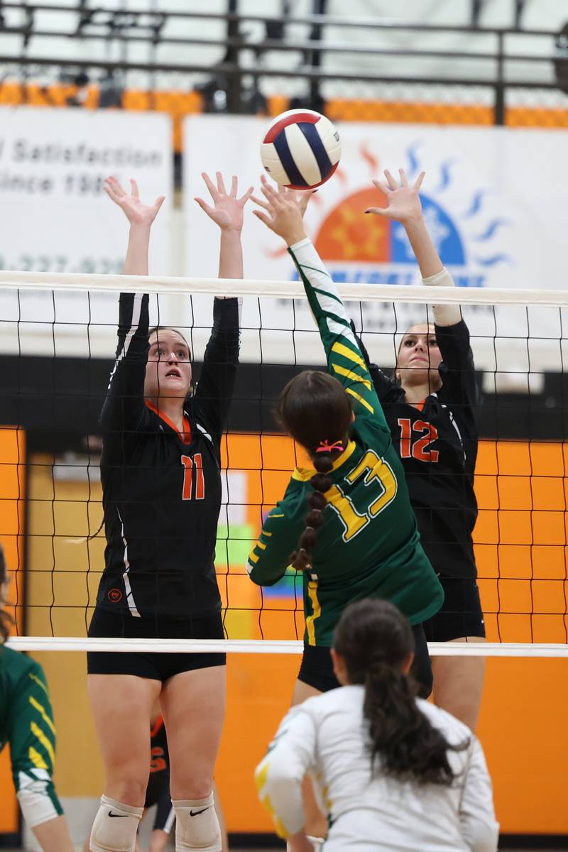 Beecher's Natalie Soch, left, and Elena Kvasnicka reach to block a hit by Grant Park's MacKenna Wells during the Bobcats' victory in two sets, 25-22, 25-23, over Grant Park in the RVC championship game on Monday, Oct. 20, 2025, at Beecher High School.