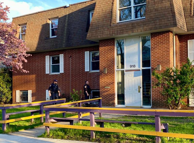 DeKalb police officers appear to search the ground for something on Monday evening, May 5, 2025, in an area outside an apartment building in the 900 block of Kimberly Drive, DeKalb. Police alerted the public to an ongoing investigation of possible gunfire in the area.