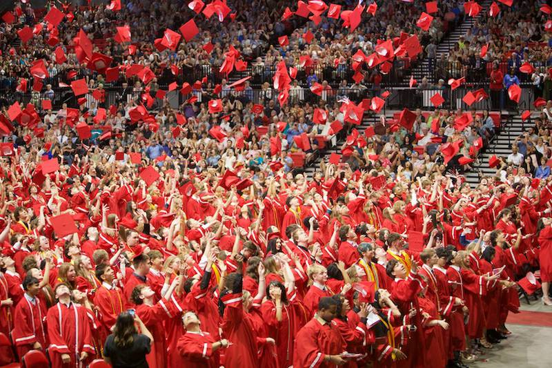 Yorkville High School Graduates throw their caps in celebration at the  Commencement Ceremony at NIU Convocation Center on Friday, May 16, 2025 in DeKalb.