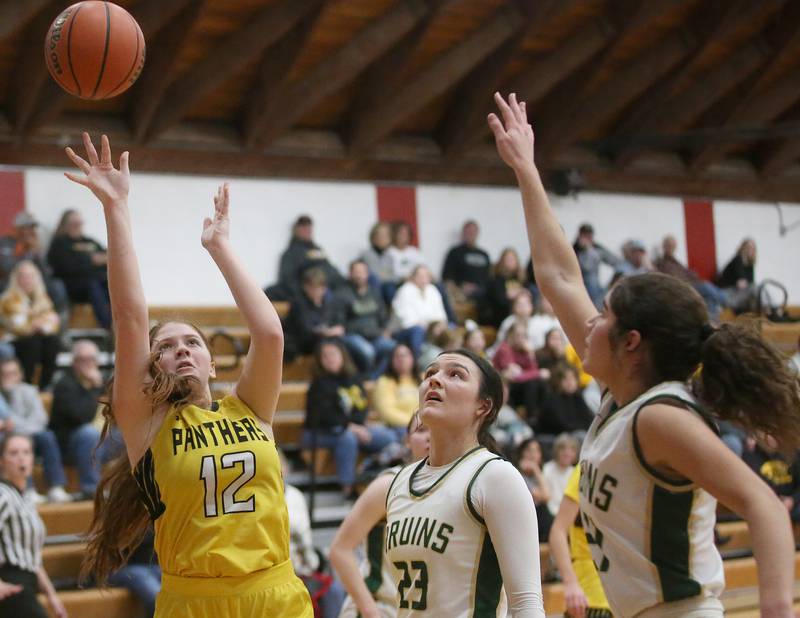 Putnam County's Maggie Spratt takes a shot over St. Bede's Ali Bosnich and Lily Bosnich during the Tri-County Conference Tournament championship game on Thursday, Jan. 18, 2024 at Henry-Senachwine High School.