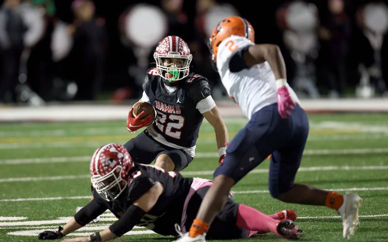 Maine South's Michael Dellumo (22) looks upfield past an Evanston player Friday October 20, 2023 in Park Ridge.