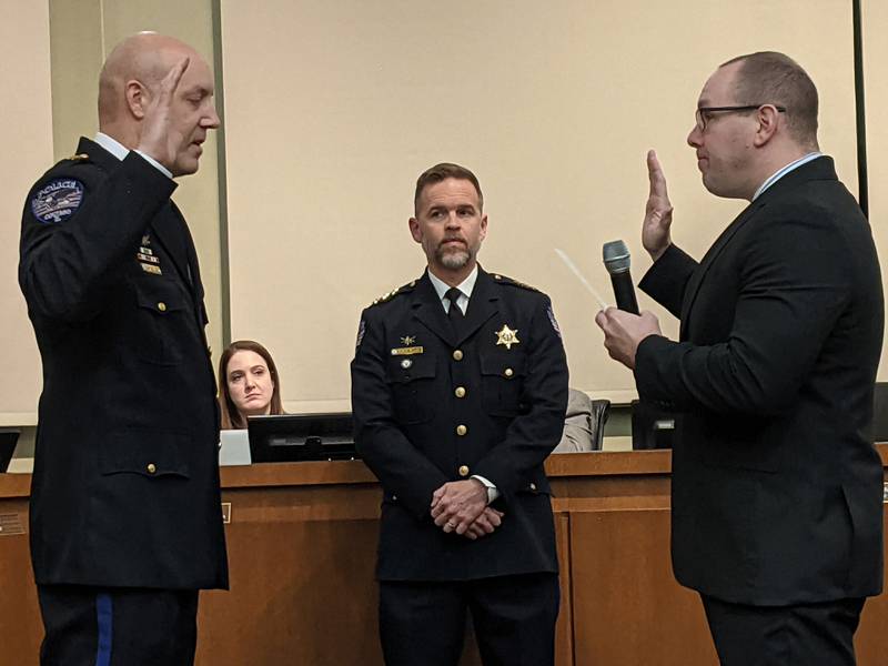 Oswego Village President Ryan Kauffman, right, swears in Drew Santa, left, as the Oswego Police Department’s new deputy chief of field operations during the Jan. 7 Oswego Village Board meeting. Looking on is Oswego Police Chief Jason Bastin, middle.