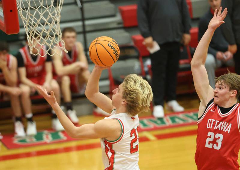 L-P's Mason Morscheiser runs in for a layup over Ottawa's Owen Sanders on Friday, Jan. 9, 2026 in Sellett Gymnasium at L-P High School.