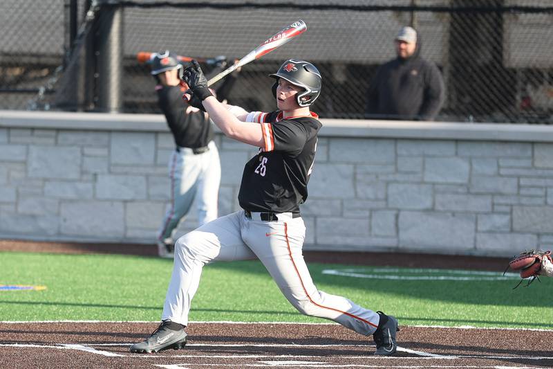 Minooka’s Conor Powers drives in a run on a single against Joliet Central on Monday, April 6, 2026 in Joliet.