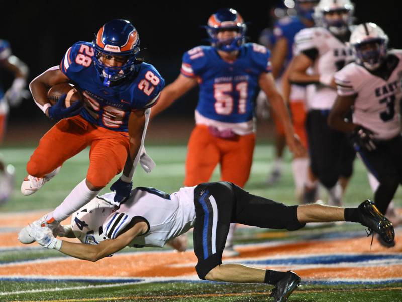 Hoffman Estates’ Landon Ford avoids an attempted tackle by Maine East’s Christopher Seeley during Friday’s football game in Hoffman Estates.