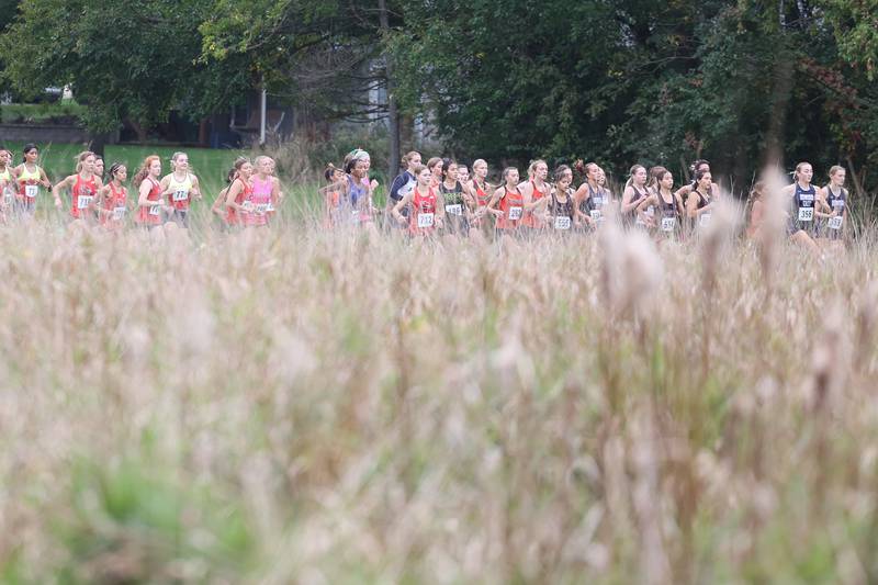 The girls take off for the Southwest Prairie Conference cross county meet at Channahon Park in Channahon on Friday, Oct. 13, 2023.