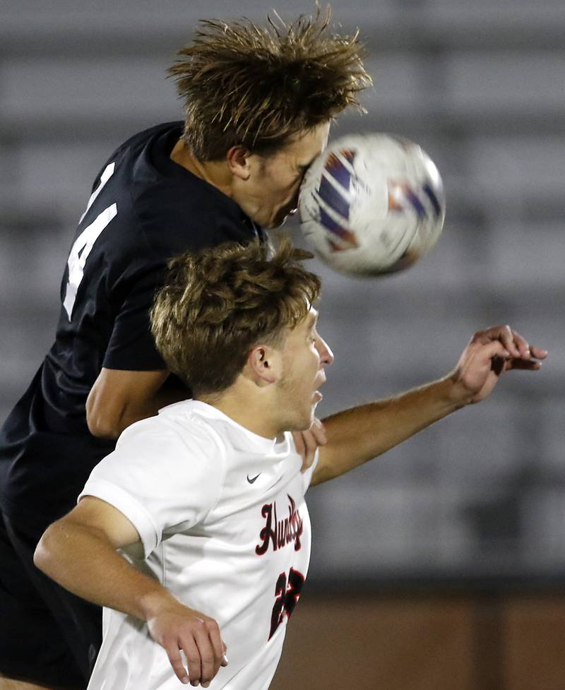 McHenry's Kyren Rivard uses his face to head the ball away from Huntley's Tyler Murray during a Fox Valley Conference boys soccer match on Thursday, Oct. 9, 2025, at McCracken Field in McHenry.