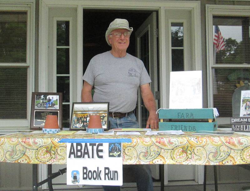 Ted McCannon, co-owner of Farm Friends in Big Rock, is ready to stamp Open Roads ABATE of IL, Inc. Summer Books.