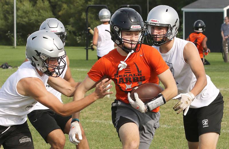 Kaneland and DeKalb players compete during 7-on-7 drills Tuesday, July 26, 2022, at Kaneland High School in Maple Park.