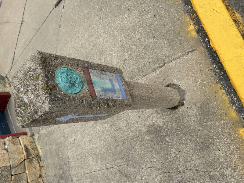 A 1928 Lincoln Highway marker stands in front of the Lincoln Highway Association's national headquarters in Franklin Grove.