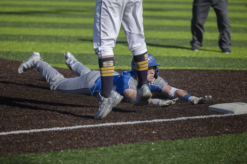 Newman’s Jaesen Johns slides in safely for a triple against Sterling Wednesday, May 3, 2023.