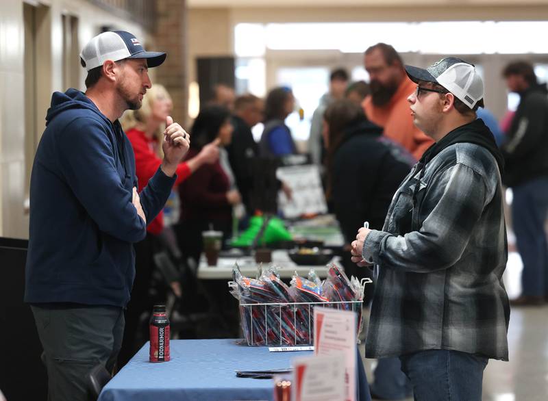 Vistors receive information from one of the booths Wednesday, Oct. 22, 2025, during Trades Exploration Day at DeKalb High School. The event hosted several companies and organizations that were offering information on opportunities in the trades.