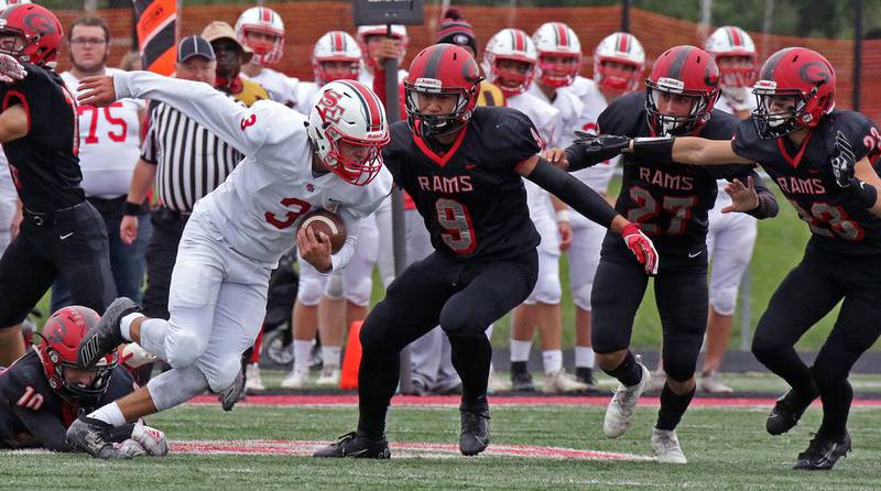 The Glenbard East defense pursues South Elgin ball carrier Alex Noworol during a game in Lombard on Sept. 28.