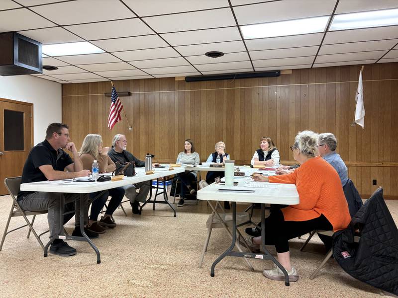 Board members discuss the new trash service during the Grand Ridge Village Board meeting on Tuesday night.