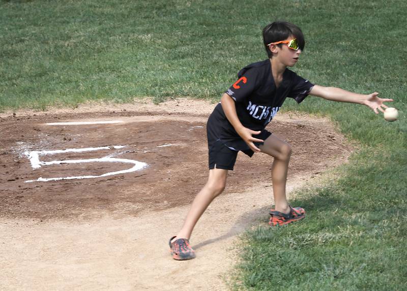Alan Kroll's jersey number takes center stage on the pitching mound as a player tries to field the ball during a celebration of life Wiffle ball game in his memory Monday, June 30, 2025, at the McHenry VFW. Alan, 11, was killed in a June 23 crash near Marengo. Over 50, kids of all ages to part in the game to have fun in his memory.