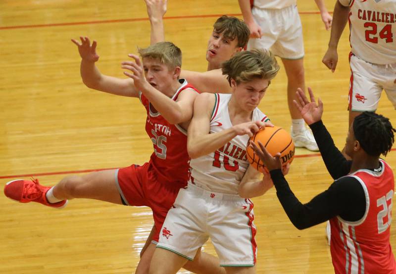 L-P's Braylin Bond (center) grabs a rebound over Streator's Joseph Hoekstra whie Streator's Tristan Finley (right) looks to take it back on Tuesday, Jan. 14, 2025 in Sellett Gymnasium at L-P High School.