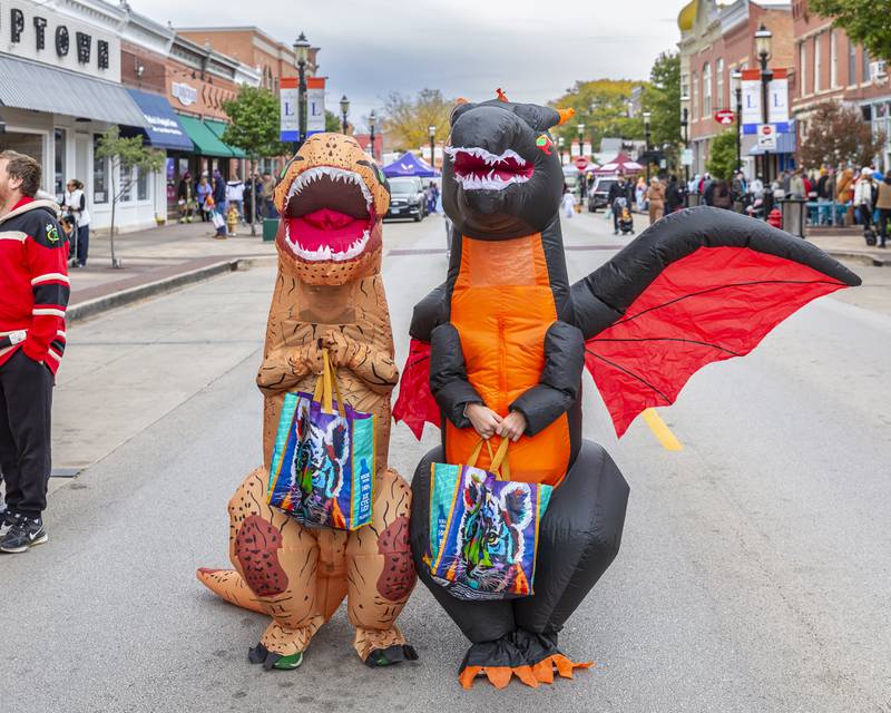 T-Rex and Dragon siblings attend the Plainfield Spooktacular Trick-or-treating event Saturday Oct 25, 2025 in Plainfield.