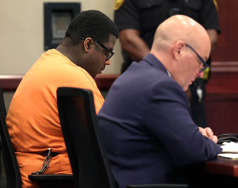 Timothy Doll, (left) who pleaded guilty to murdering DeKalb High School freshman Gracie Sasso-Cleveland in 2023, and his attorney Andrew Nickel, have their heads bowed as they listen to Gracie’s mom Ericka Sasso read her victims impact statement Thursday, Aug. 14, 2025, at the DeKalb County Courthouse in Sycamore. Doll was sentenced to 52 years in prison.